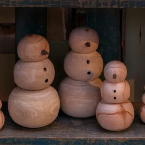 A group of wooden snowmen sitting next to each other