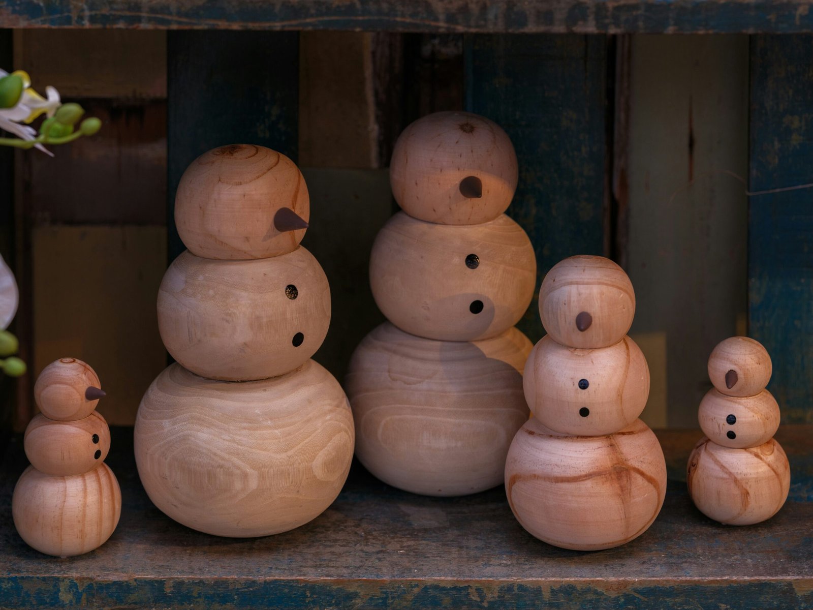A group of wooden snowmen sitting next to each other